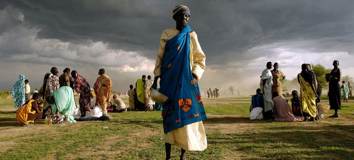 https://www.dabangasudan.org/wp-content/uploads/2023/04/An-elderly-woman-internally-displaced-from-her-home-in-Abyei-in-Sudan-gets-ready-to-receive-her-ration-of-emergency-food-aid-UN-Photo-Tim-McKulka.jpeg